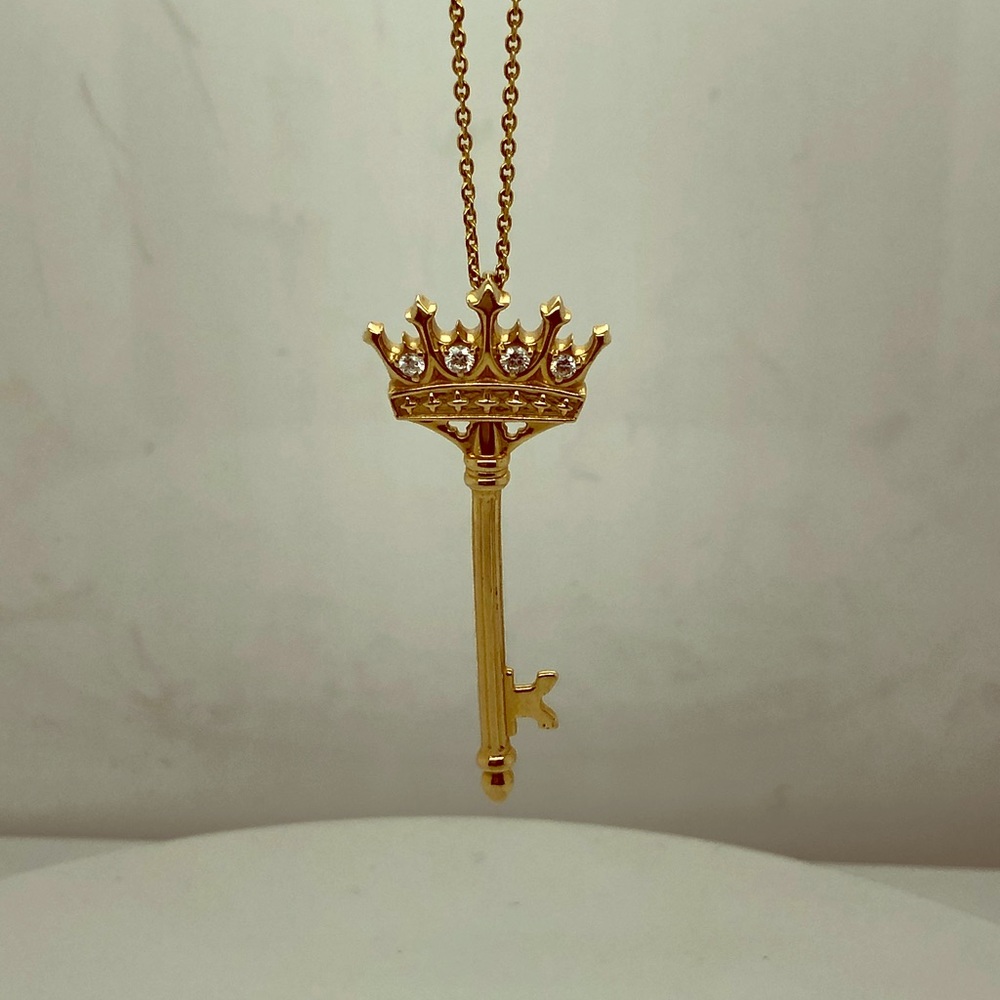 14k yellow gold crown key pendant.